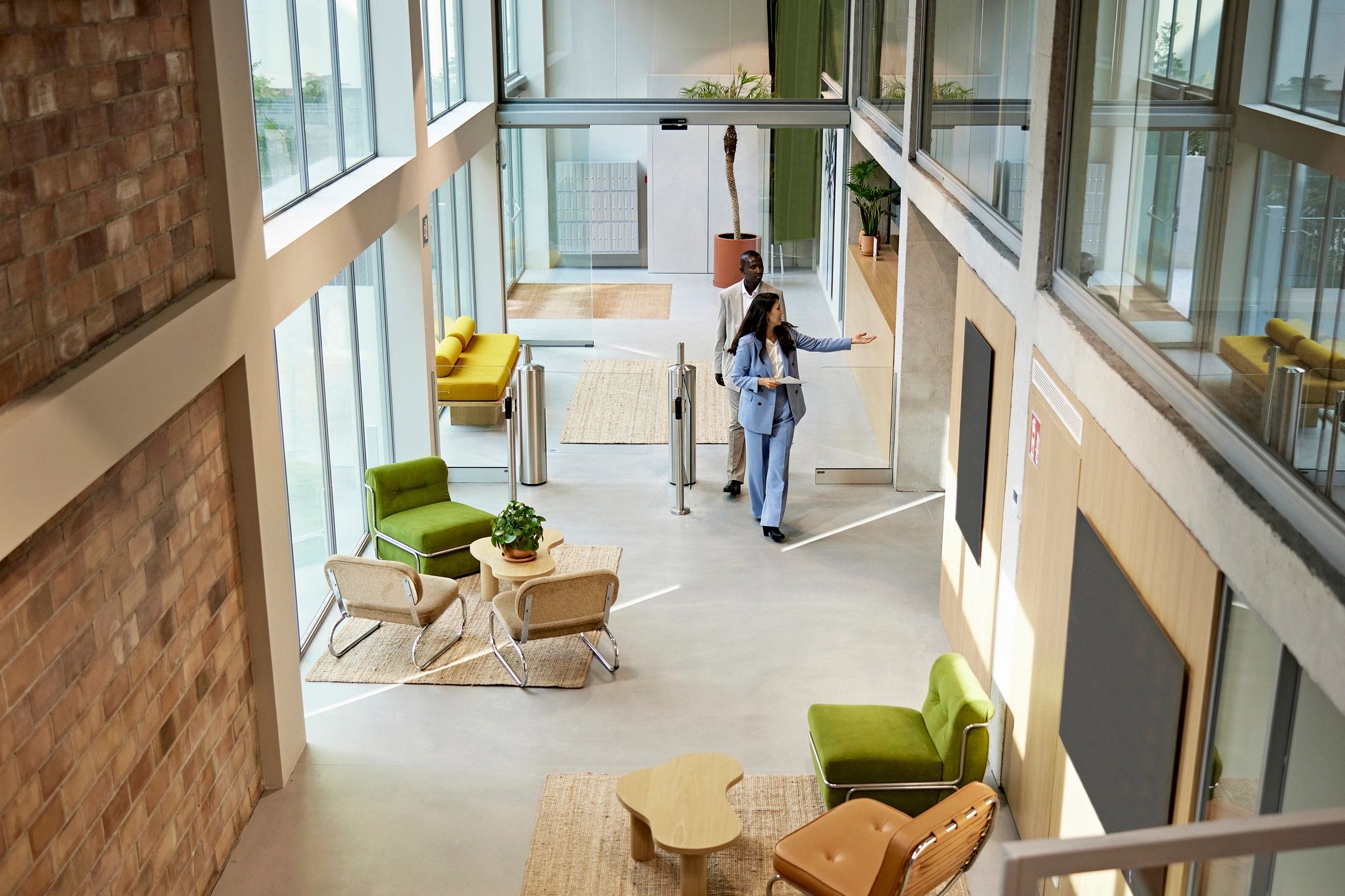 Real estate advisor meeting a client in a modern office lobby